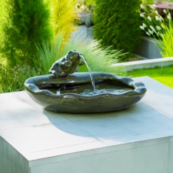 Whimsical Green Ceramic Frog Solar-Powered Cascading Fountain – Outdoor Garden & Patio Decor -The Birdhouse Chick Little Green Frog Ceramic Solar Fountain in Garden Setting